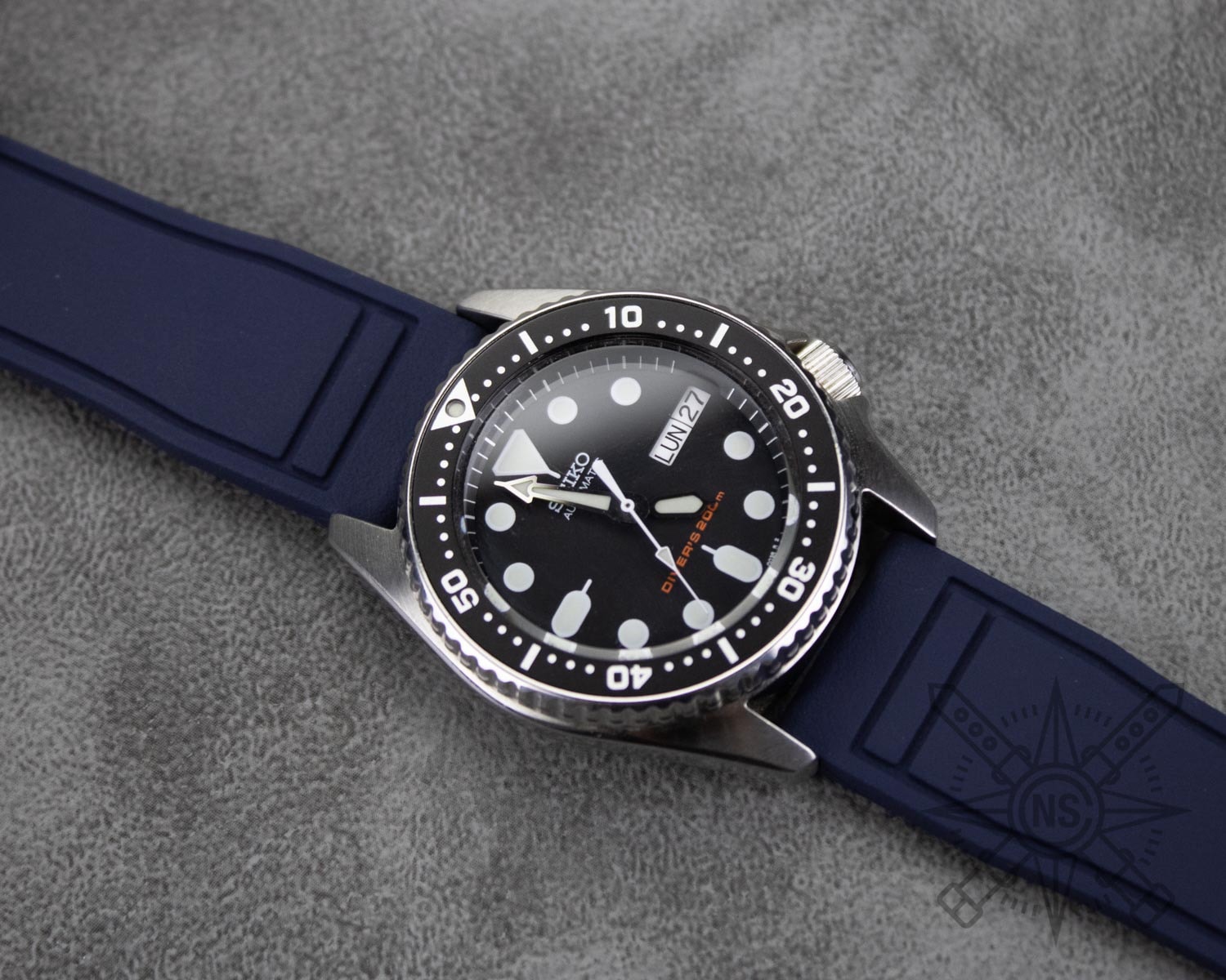 A stylish navy blue rubber watch strap displayed on a timepiece.