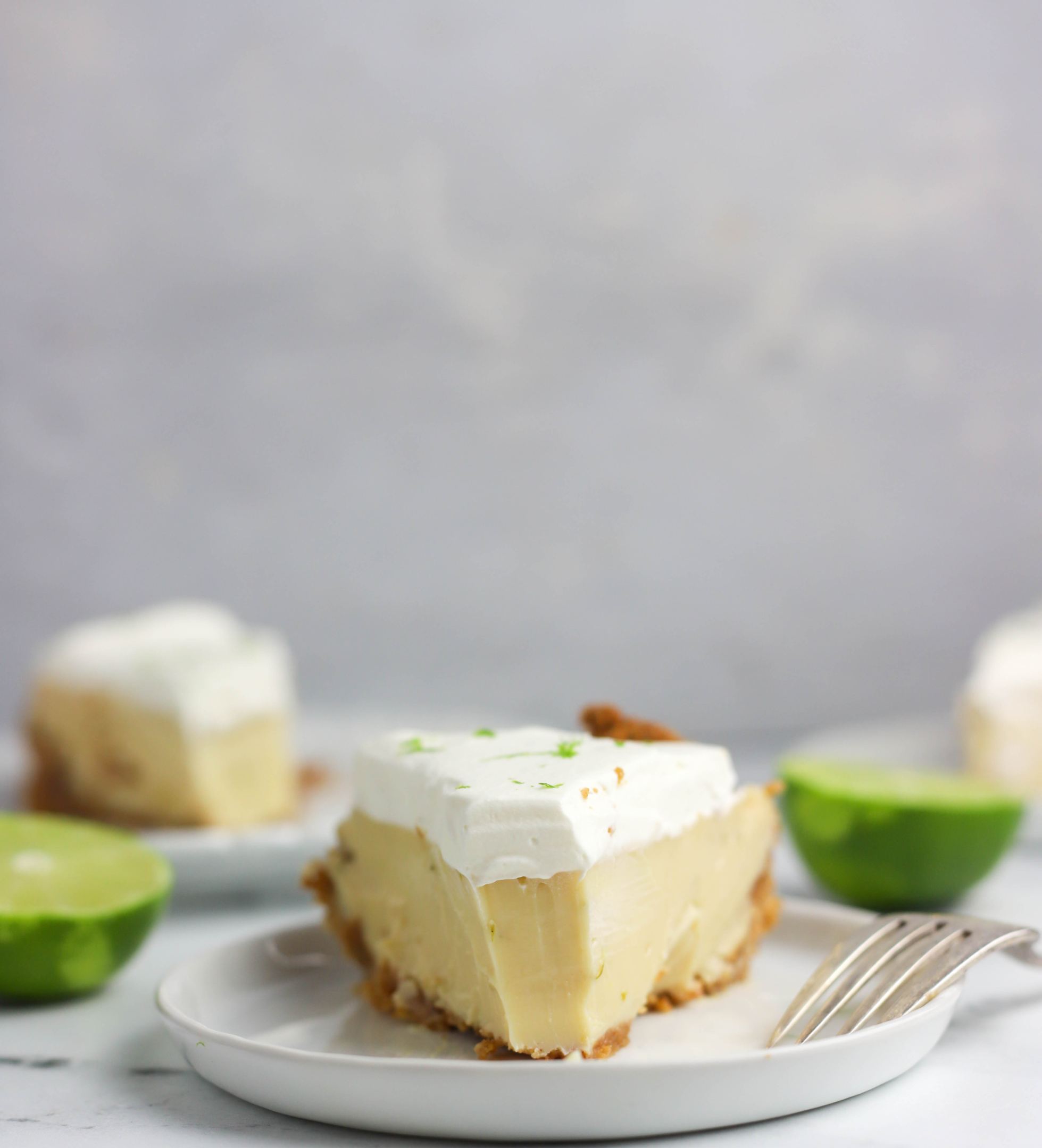 slice of key lime pie on a plate with a fork