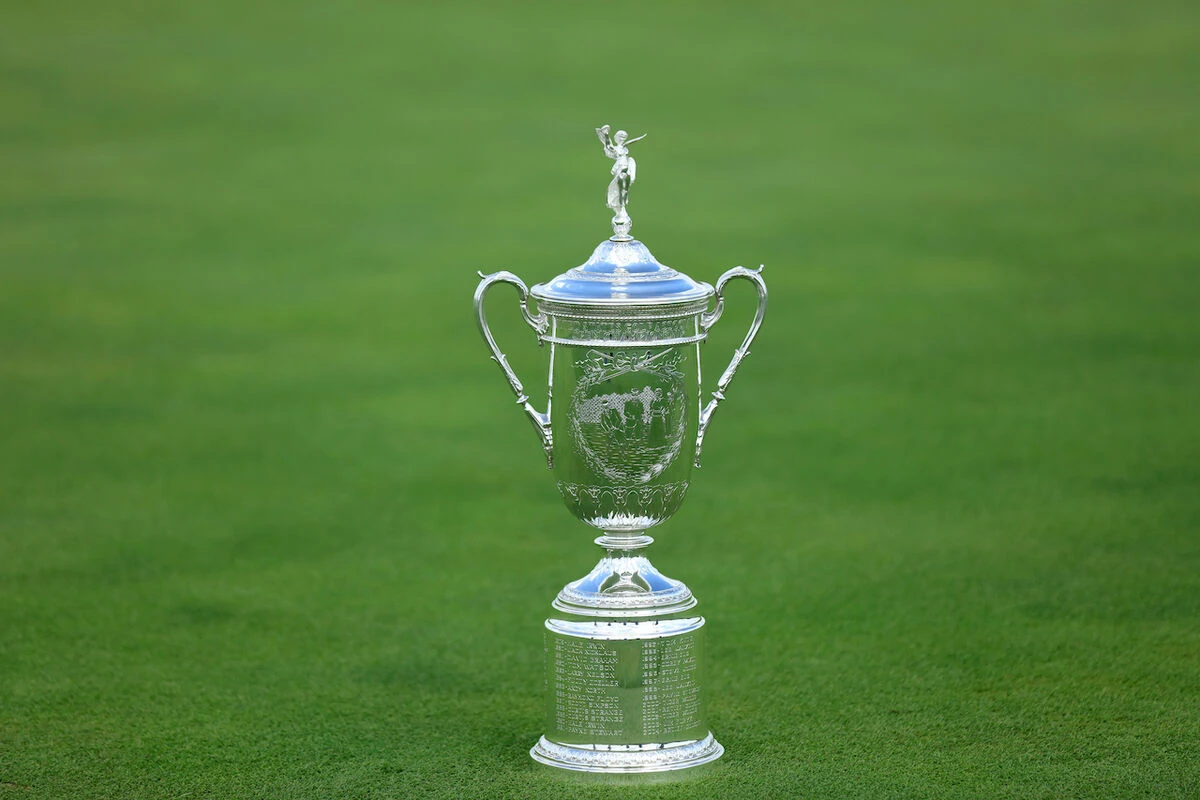 The U.S. Open Championship Trophy sitting on a golf green.
