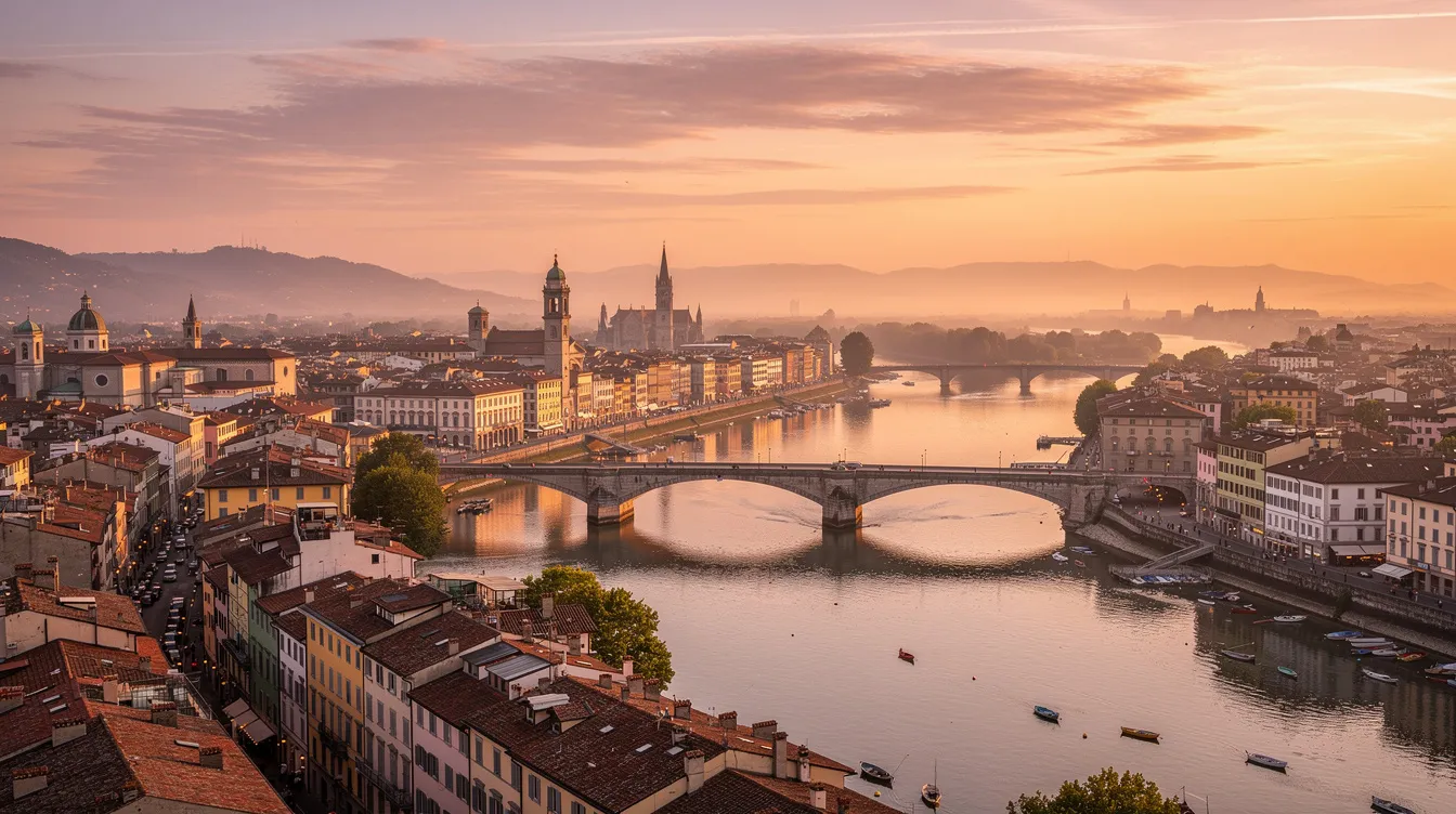 A imagem mostra uma vista panorâmica de uma cidade europeia ao entardecer, com um rio refletindo as cores quentes do céu e uma ponte de pedra ligando as duas margens. Ao fundo, destacam-se edifícios históricos e um castelo, criando um cenário encantador que atrai turistas e amantes da história.
