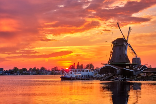 Sunset over lake and behind windmills in the Netherlands 