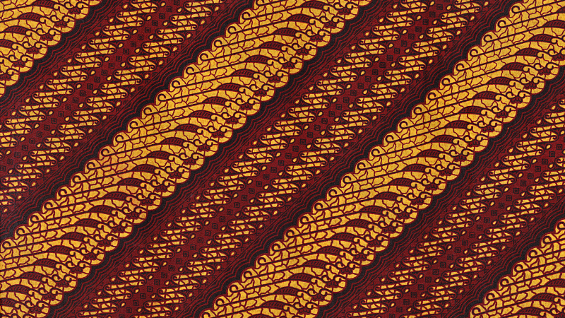An image of a red and gold patterned Parang fabric