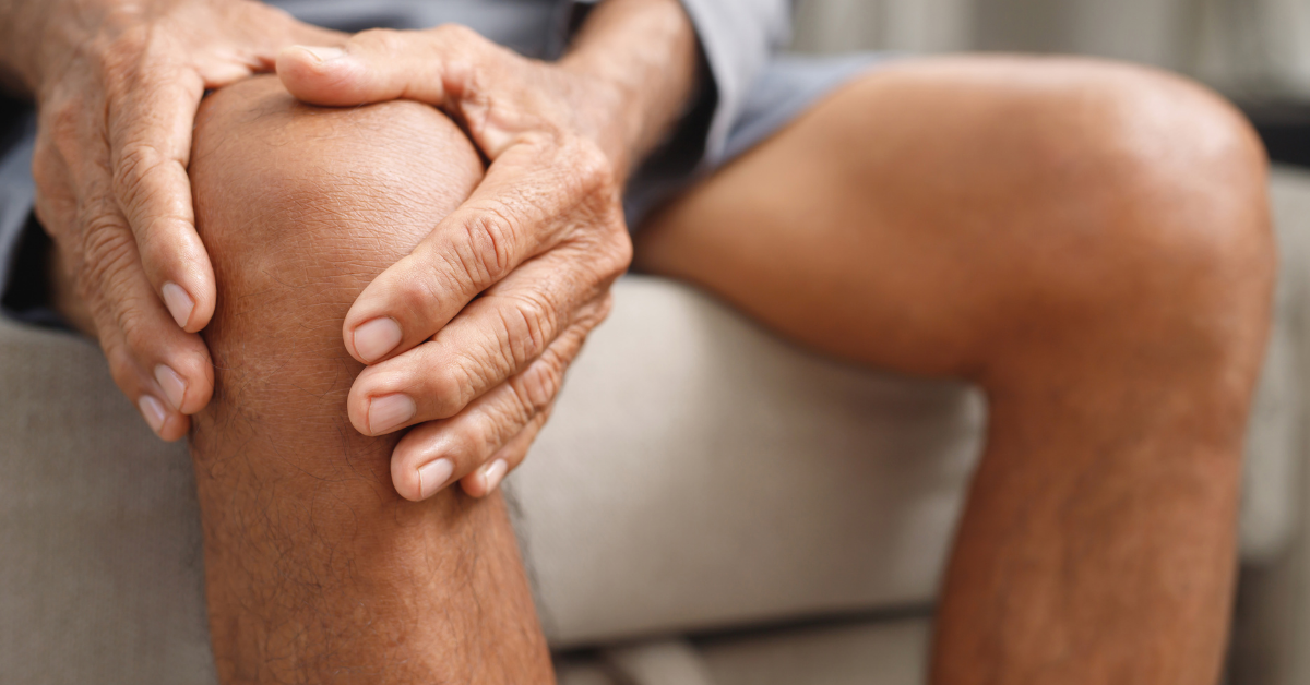A person holding their knee with reduced inflammation after cold plunging.