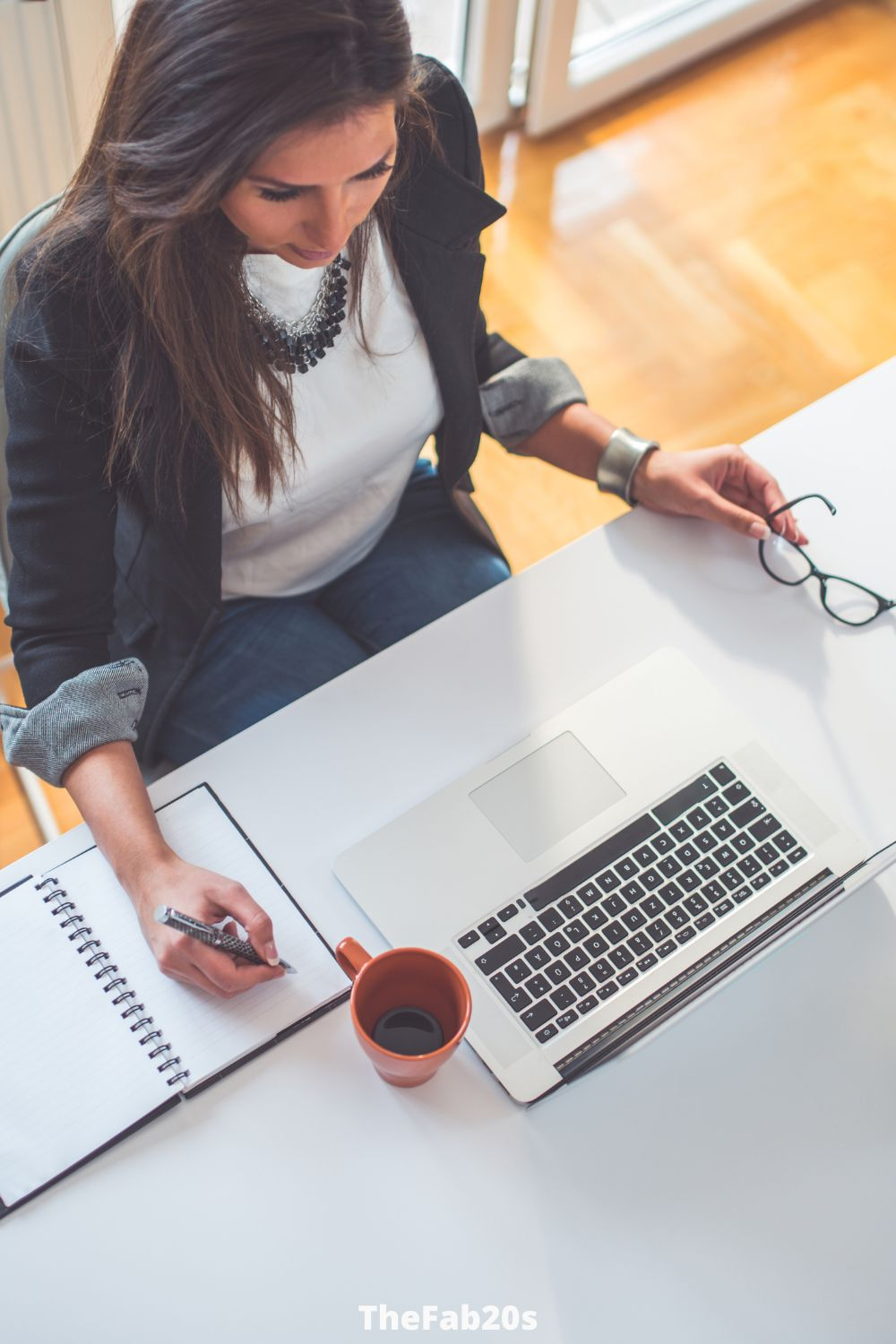 Woman working hard at her desk - Featured In Article about Gemini partner being strongly attracted to Scorpios