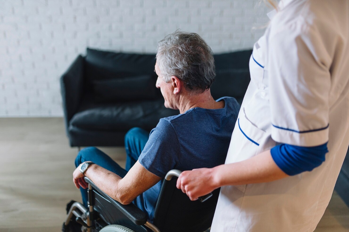 Man escorting an elderly to a medical appoinment