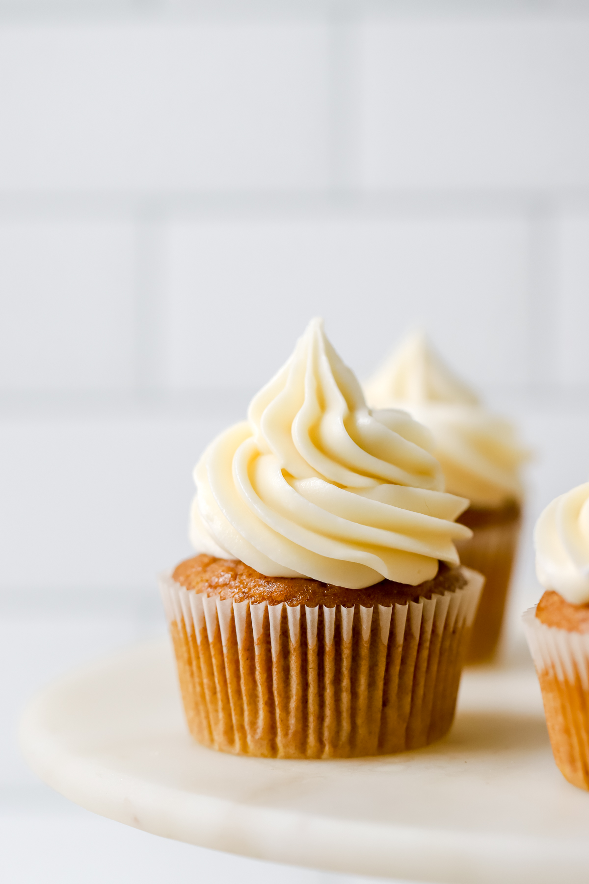pumpkin cupcake topped with cream cheese frosting