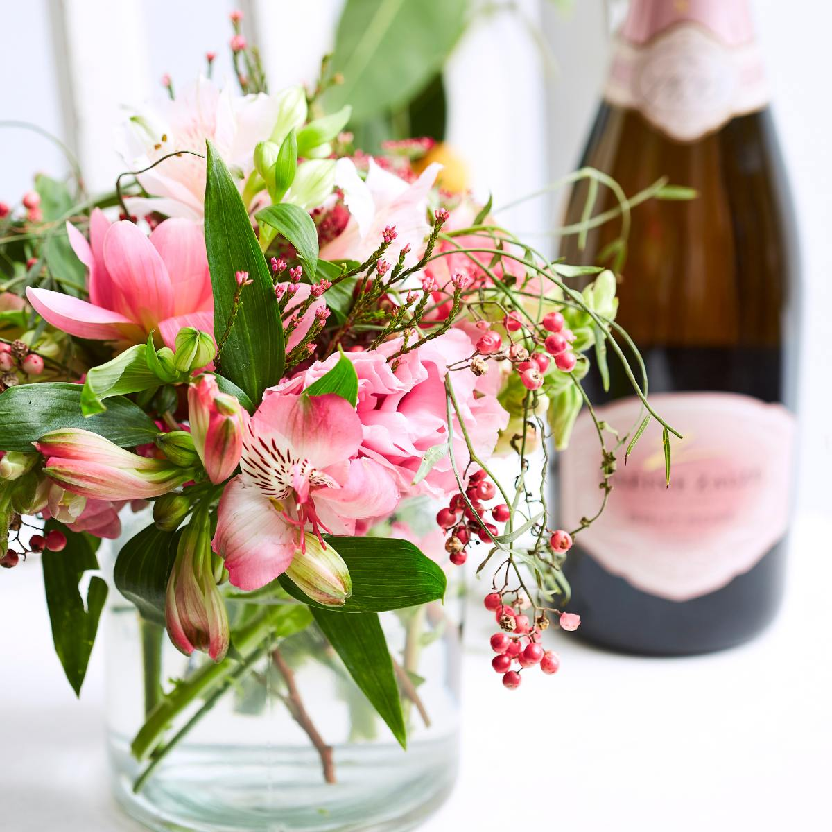 small pink flower arrangement with champagne