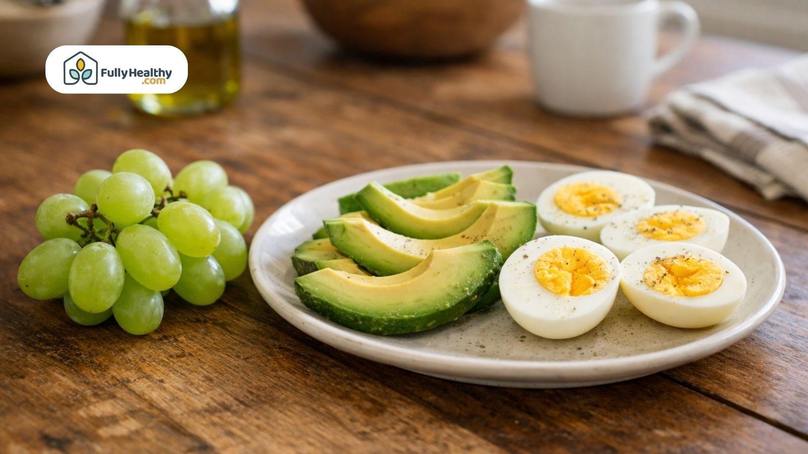Plate with fresh grapes, sliced avocado, and hard-boiled eggs.