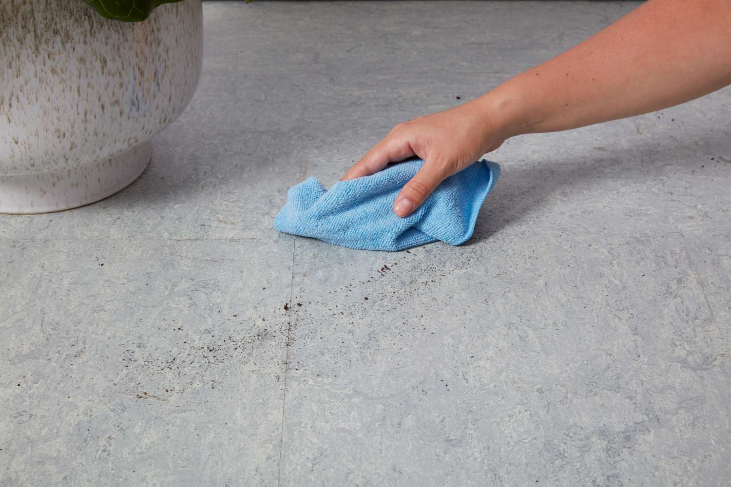 Wipe your dirty linoleum floors using a dry microfiber cloth