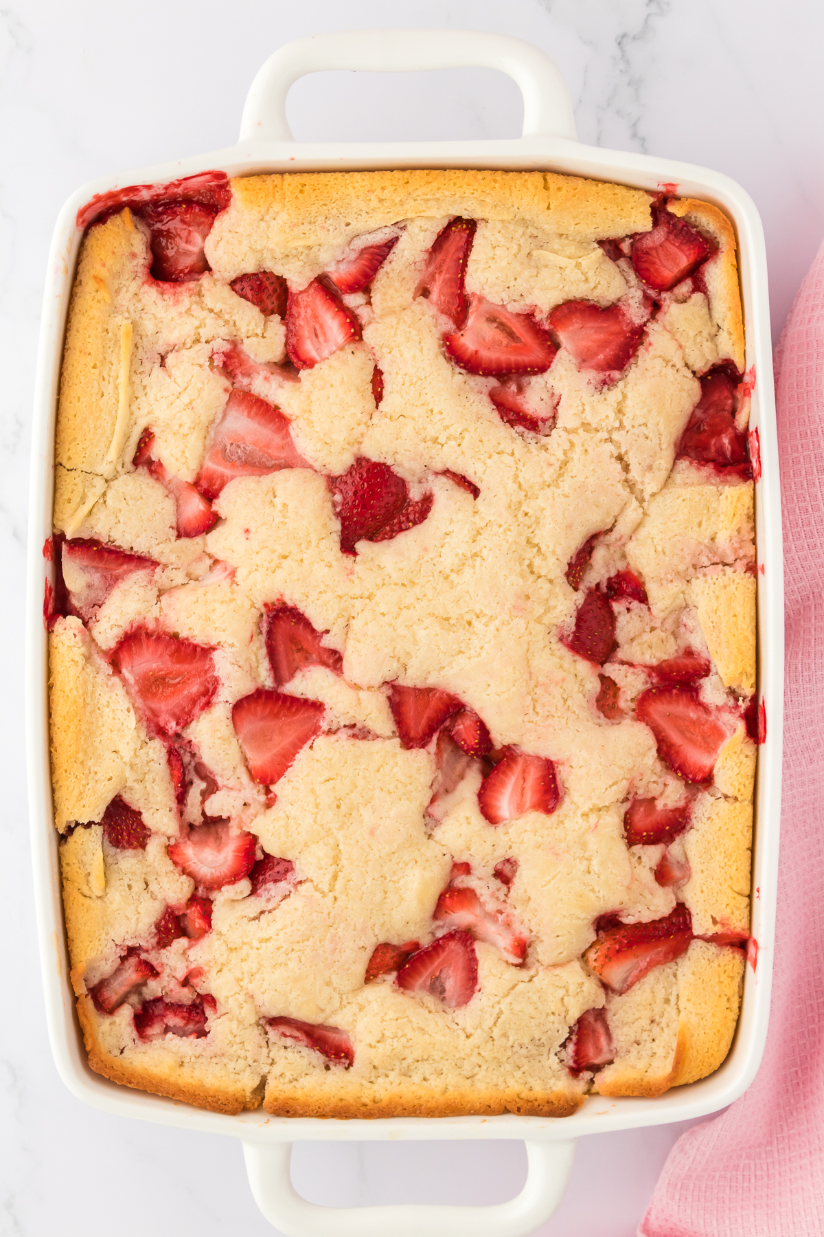 baked strawberry cobbler in 9x13 inch baking dish