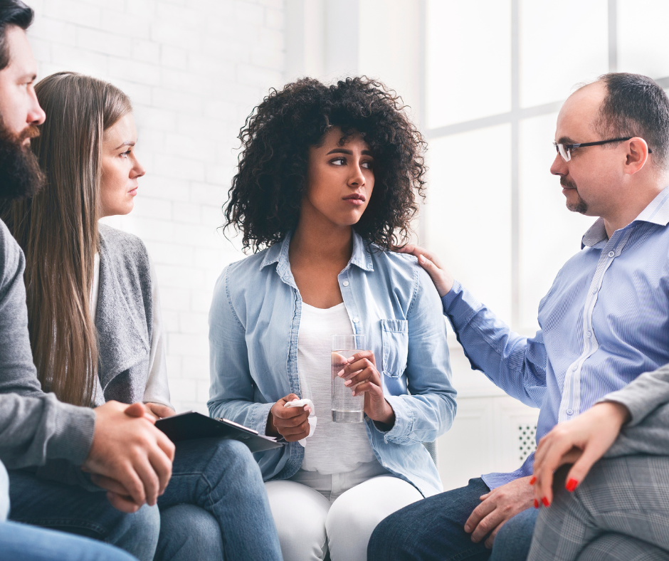                                        A group of people discussing addiction treatment options in a holistic setting