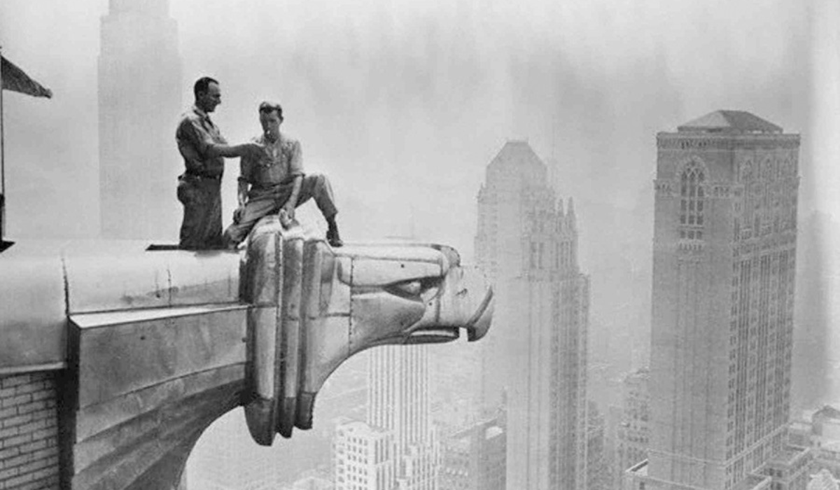 Art deco movement - art deco architecture - two men sitting high up on a skyscrapper