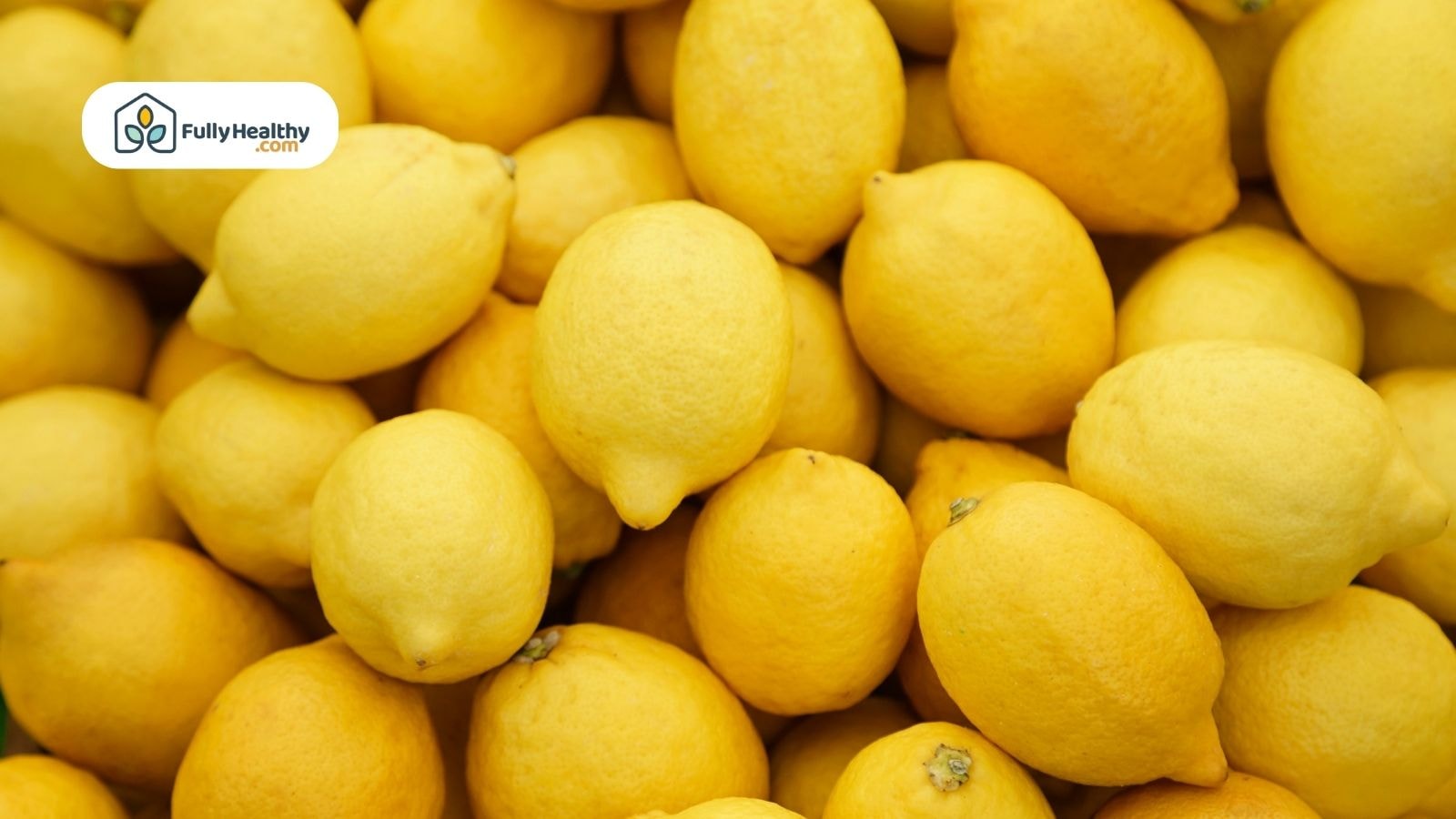 Whole fresh lemons piled together displaying natural yellow citrus fruit color