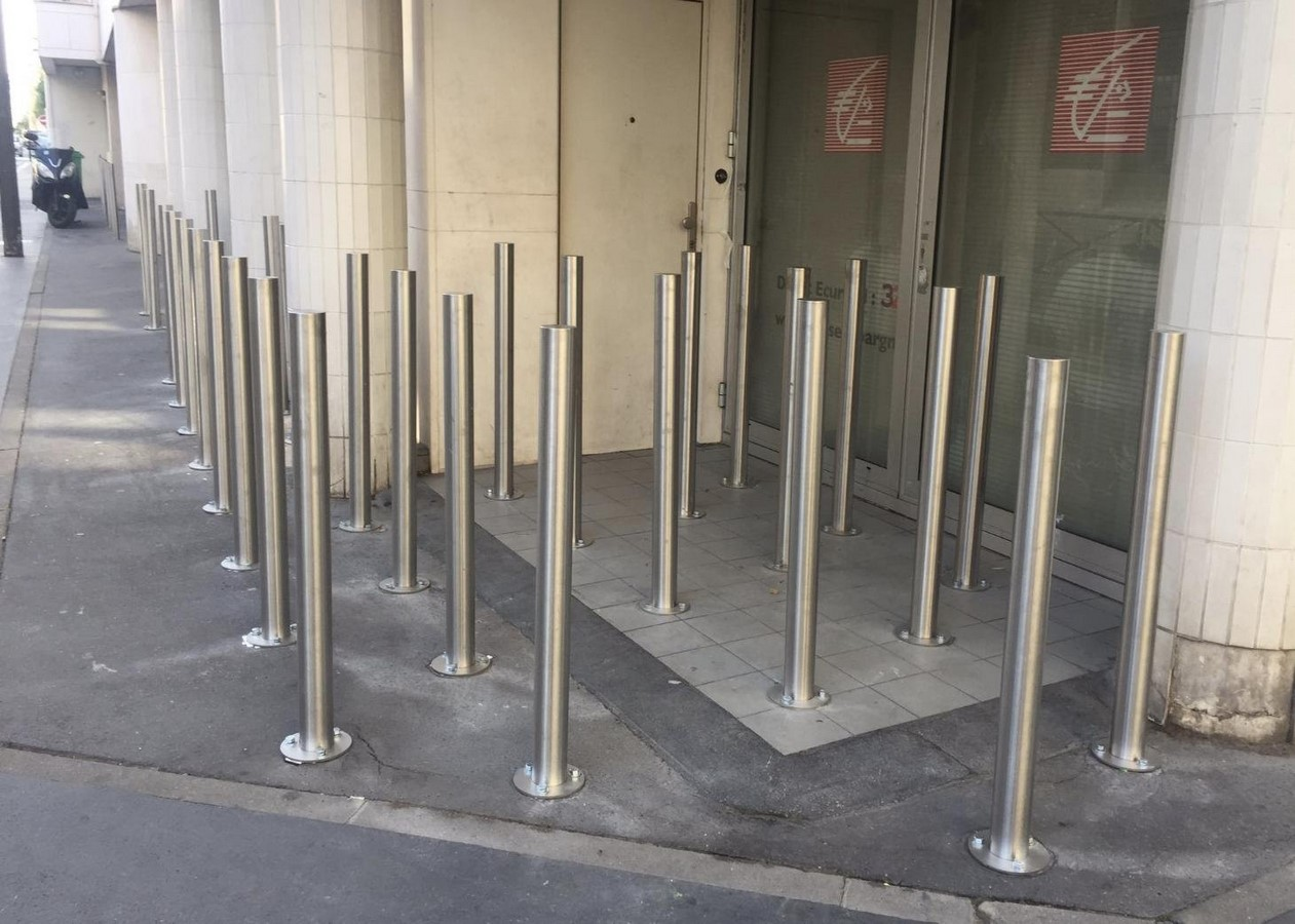 Metal poles blocking a building's corner