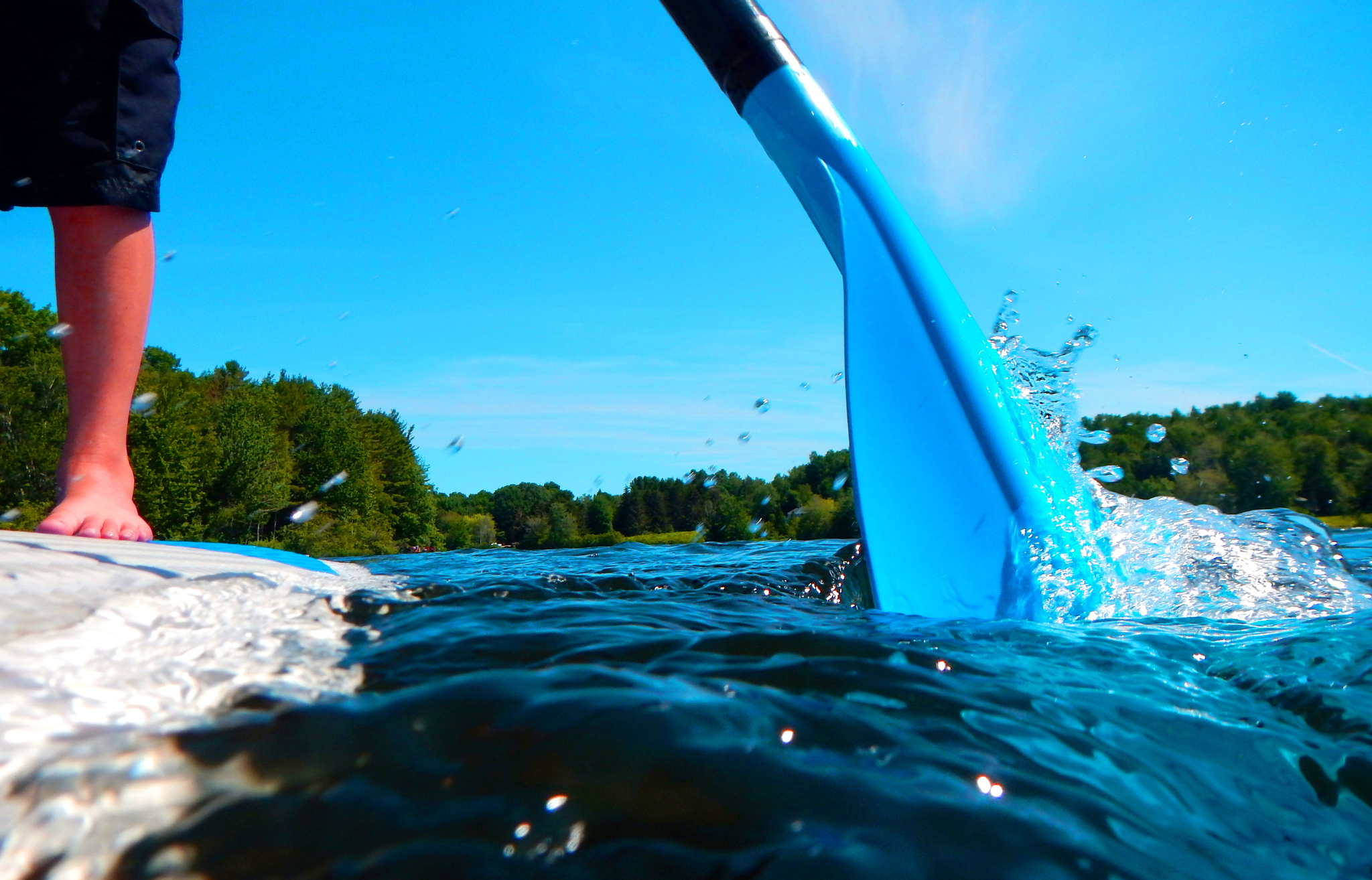Close-up of paddle hitting the water - Adventure Wie Travel Gear