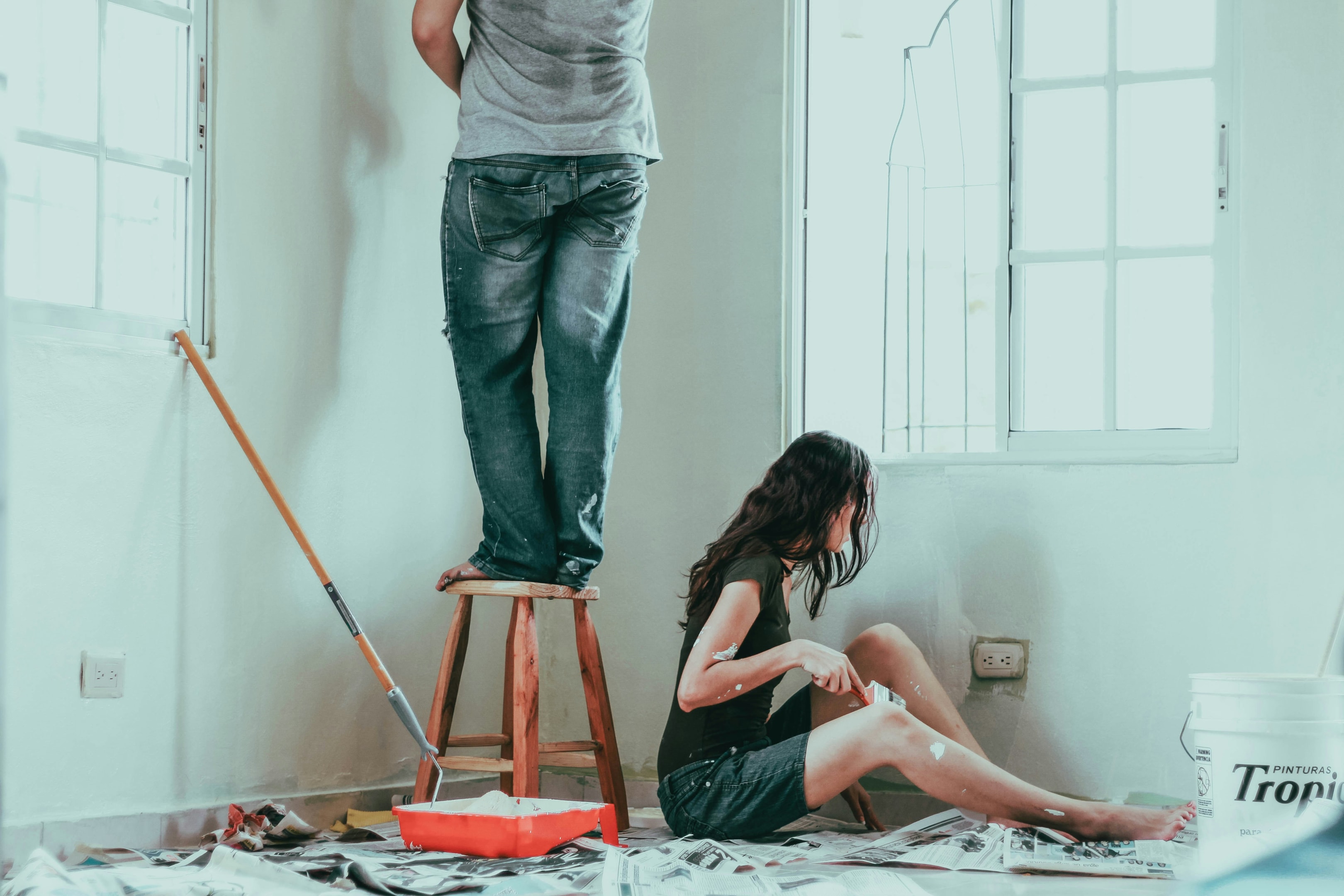 a couple painting around a replaced window