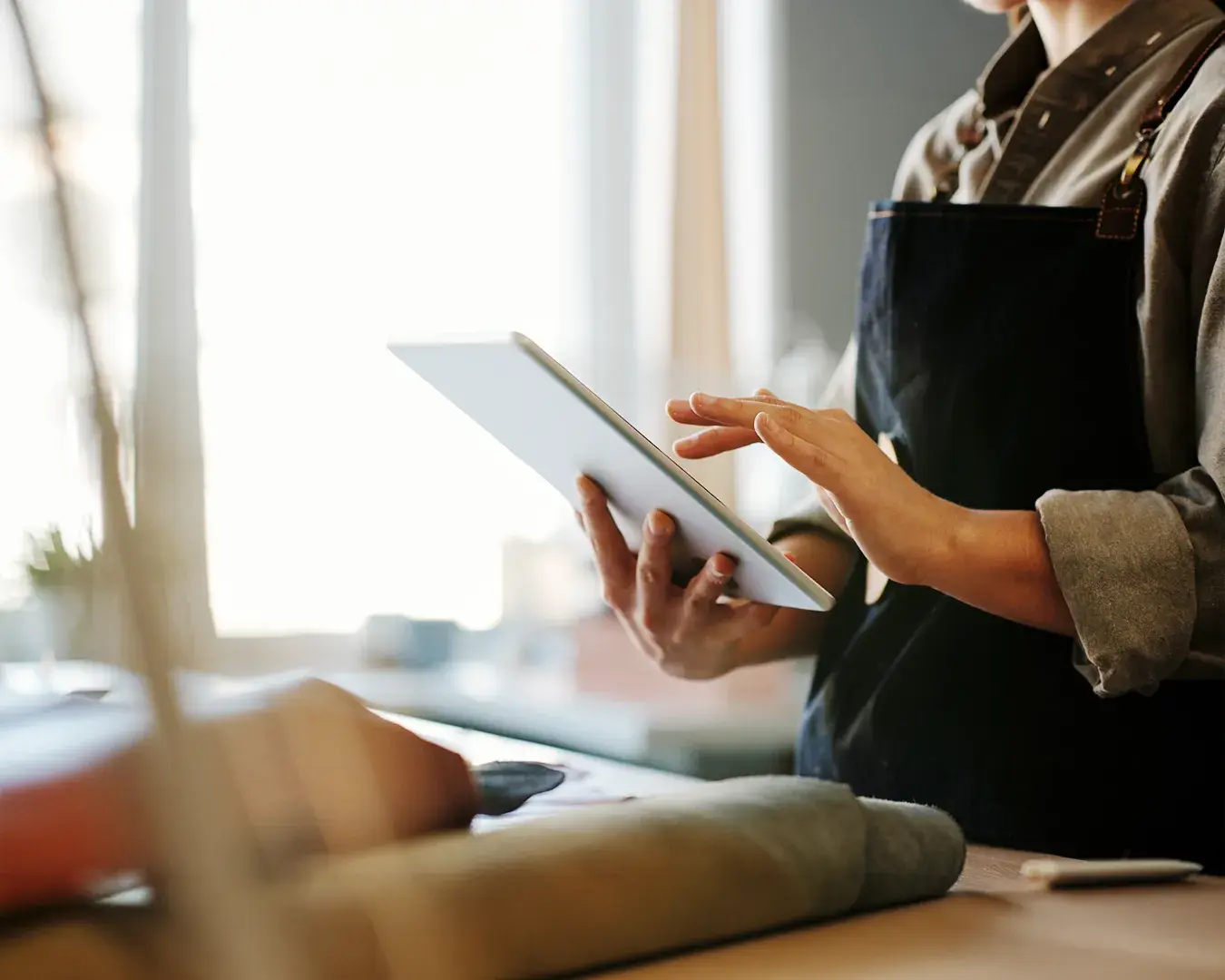 Restaurant manager using tablet to monitor digital marketing performance and customer experience in a hospitality setting
