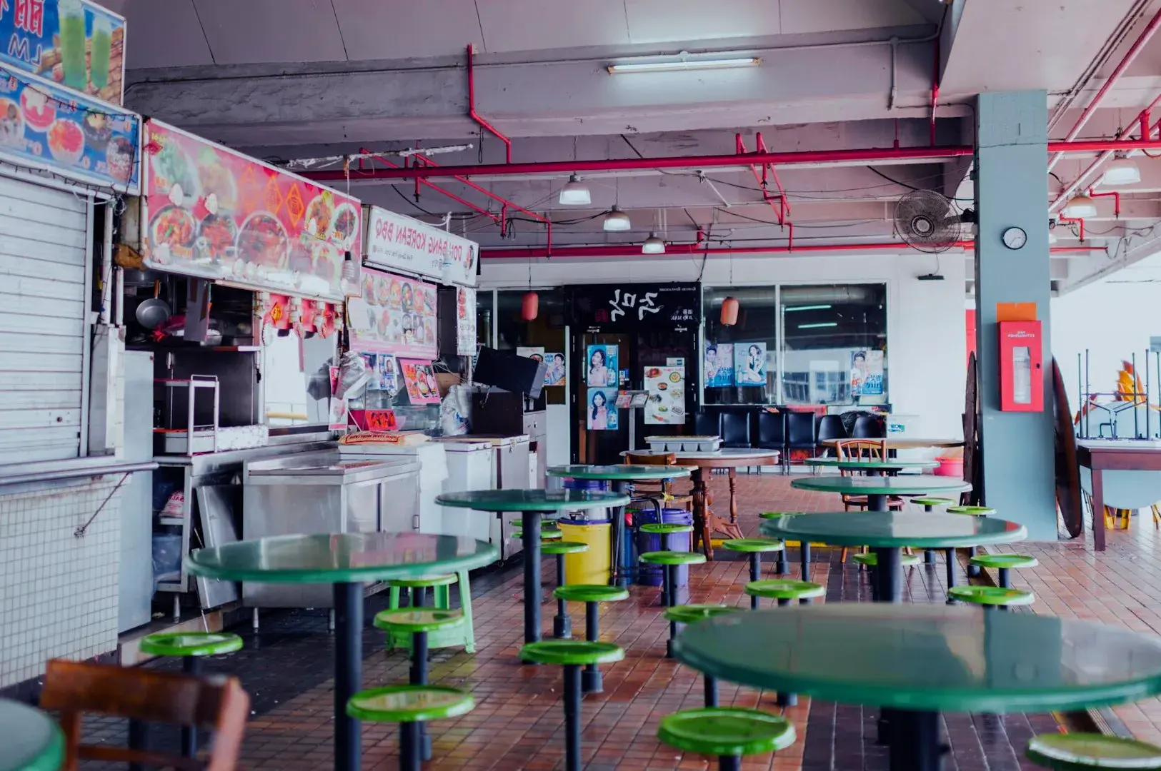 Tables and chairs set up for dining outside the Singapore Old Airport Road Food Centre, showcasing a vibrant atmosphere.