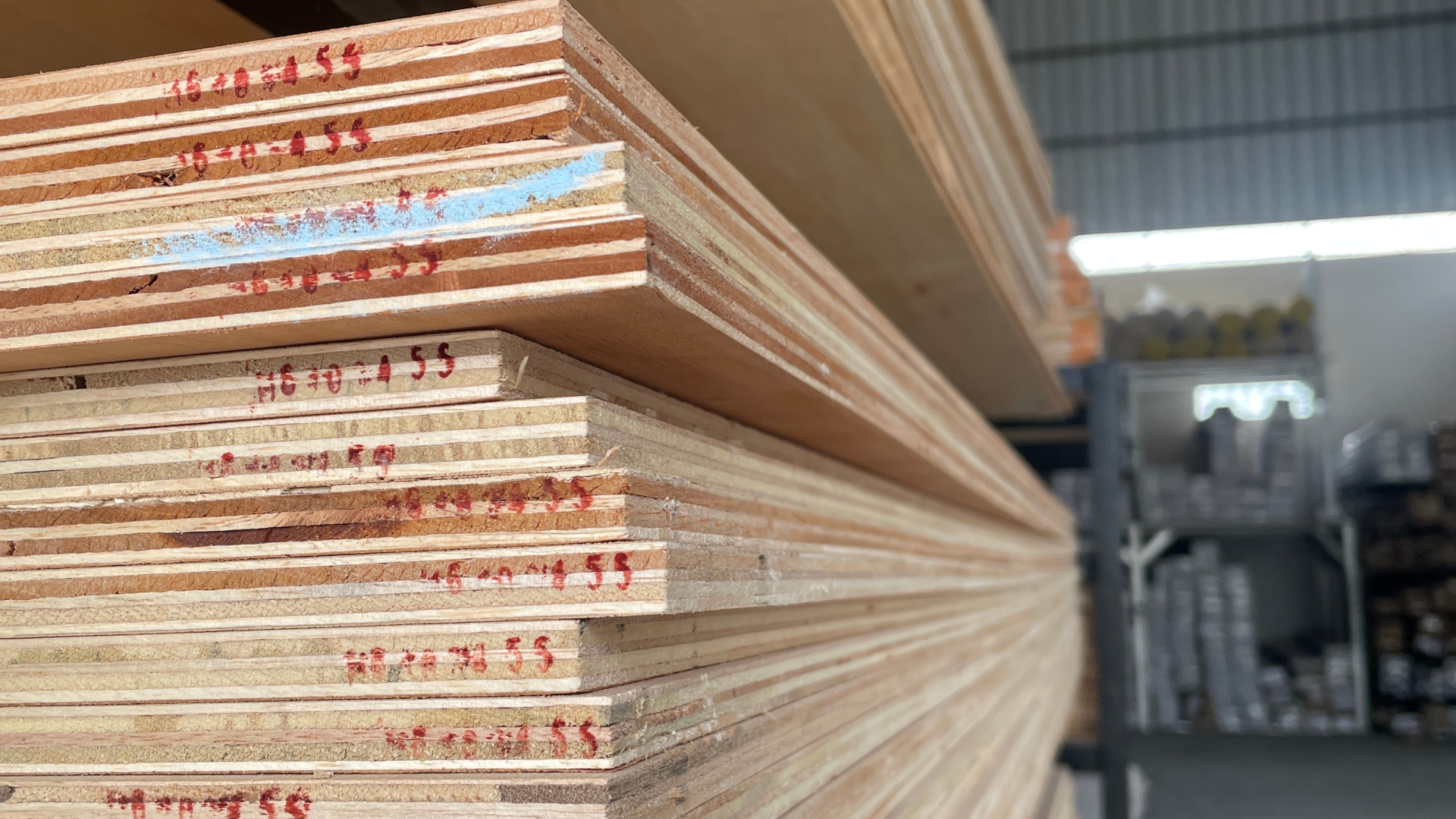 A stack of plywood in an industrial setting.