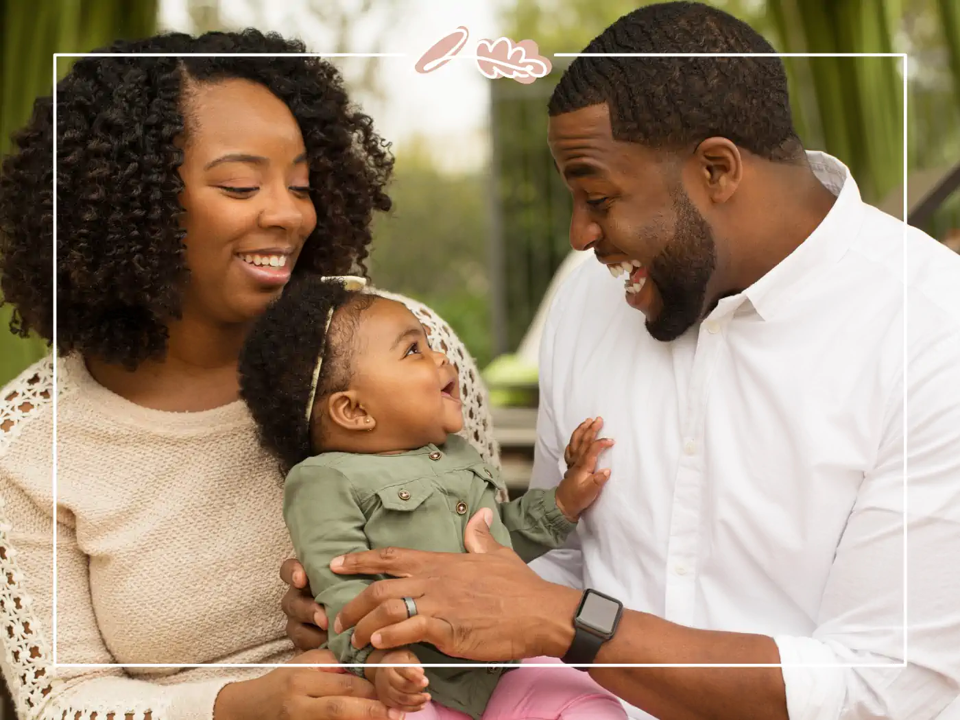 A joyful family moment with both parents smiling and holding their baby, creating a heartwarming bond. Fabulous Flowers and Gifts.