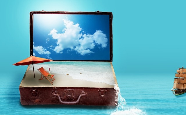 A suitcase with a fantasy image of a beach representing travel writing.