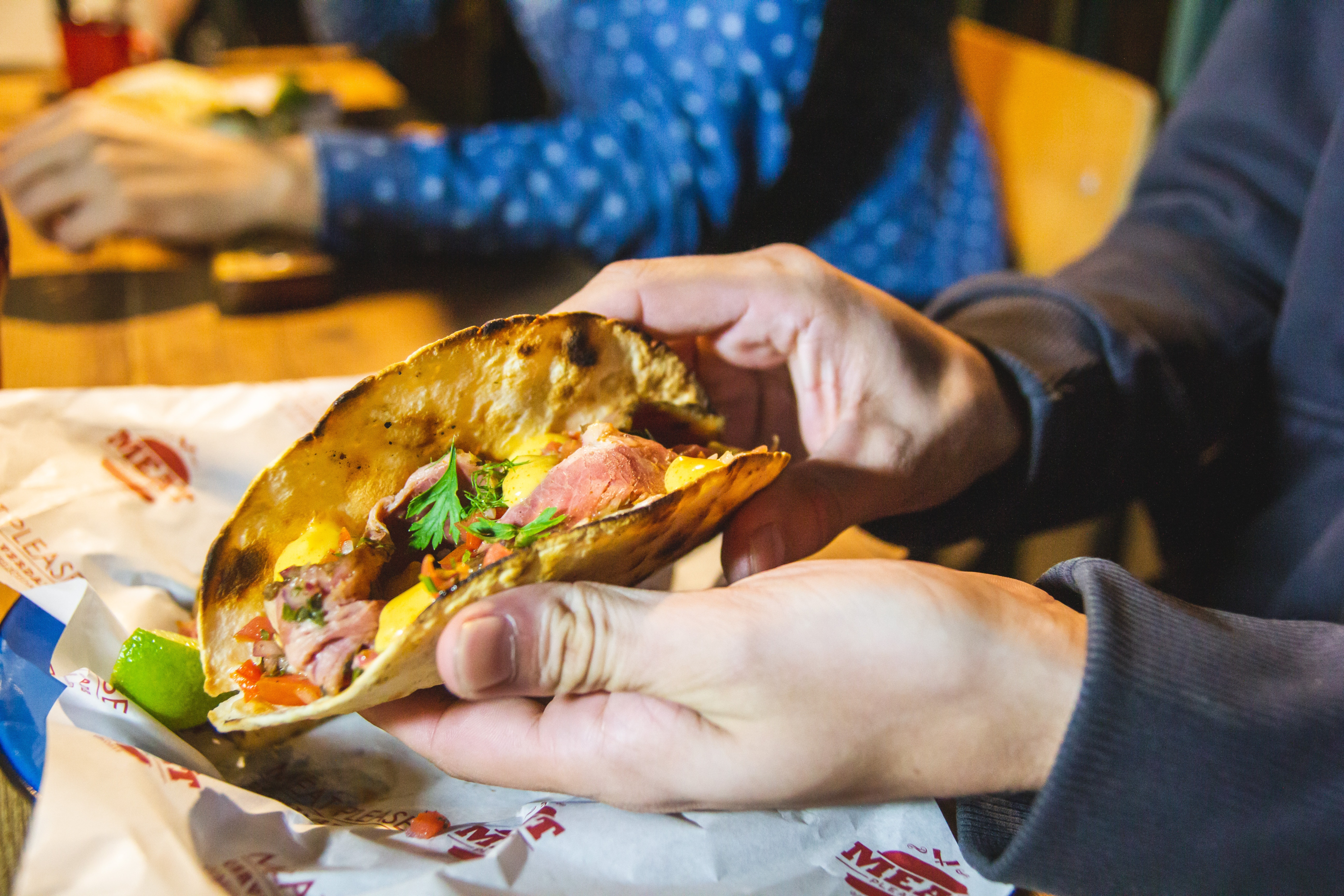 Person showing taco with parsley on top