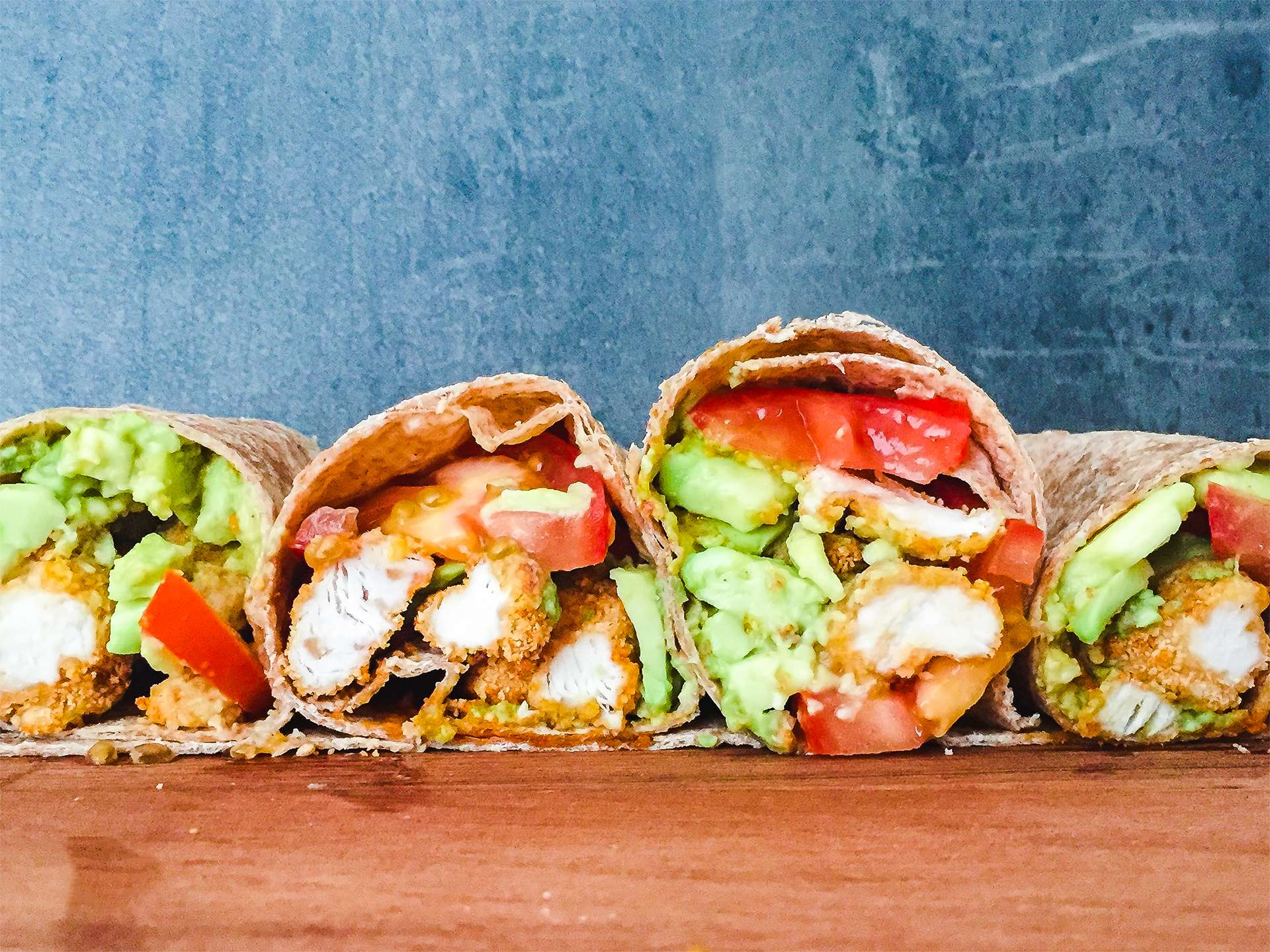 A warp with grilled chicken and avocado