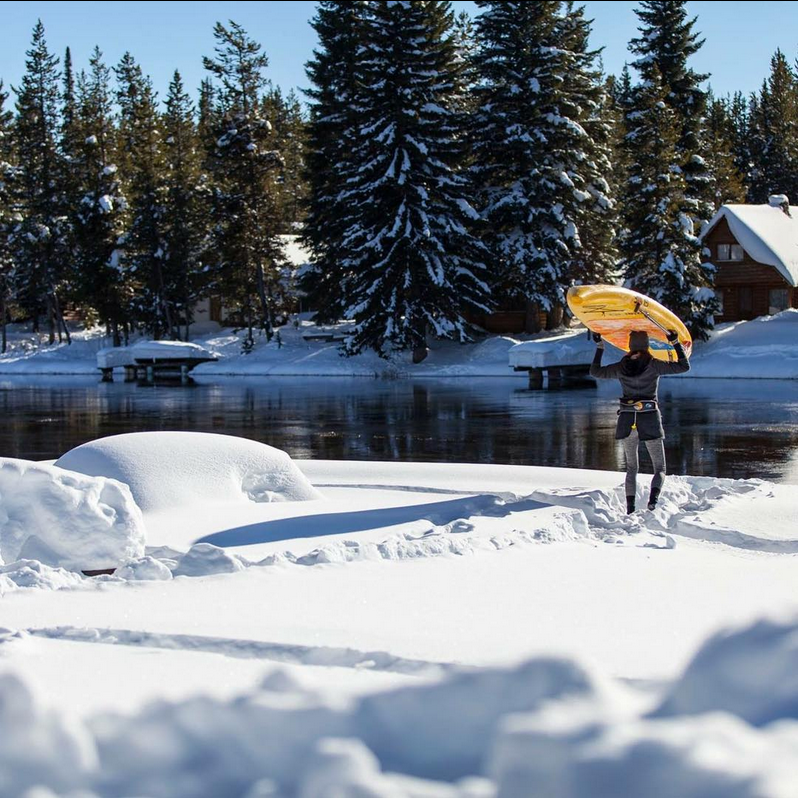 carrying a paddle board in the snow