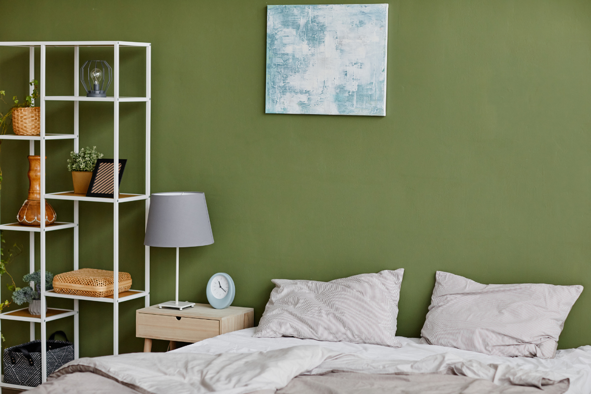 A beautifully designed room with sage green walls and complementary decor.