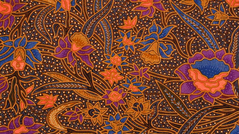 An orange and blue floral pattern batik fabric.