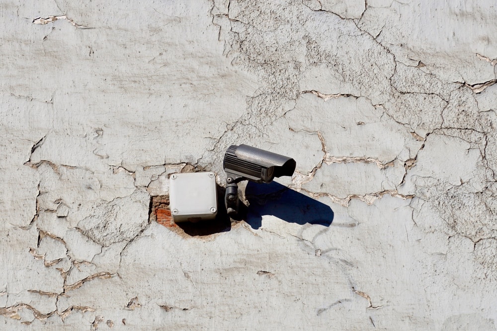 Outdated security camera on the wall of the building can be a security breach and needs a comprehensive security audit.