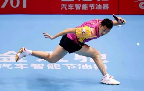 Professional ping pong player stretching out to hit a shot. The footwork of a master.