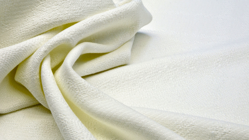 A close-up view of a white rayon fabric