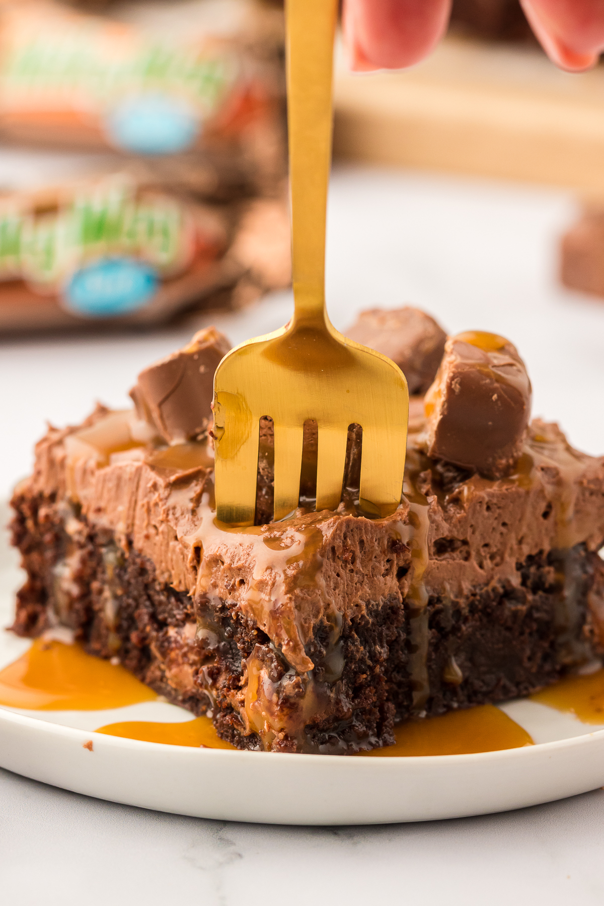 fork digging into a milky way brownie on a plate