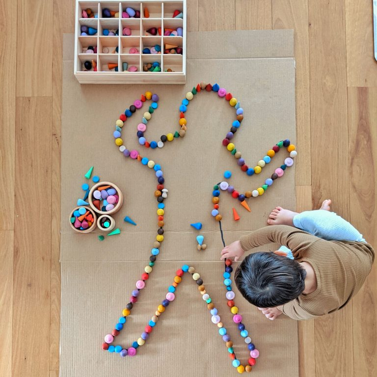A child playing with open ended materials at home