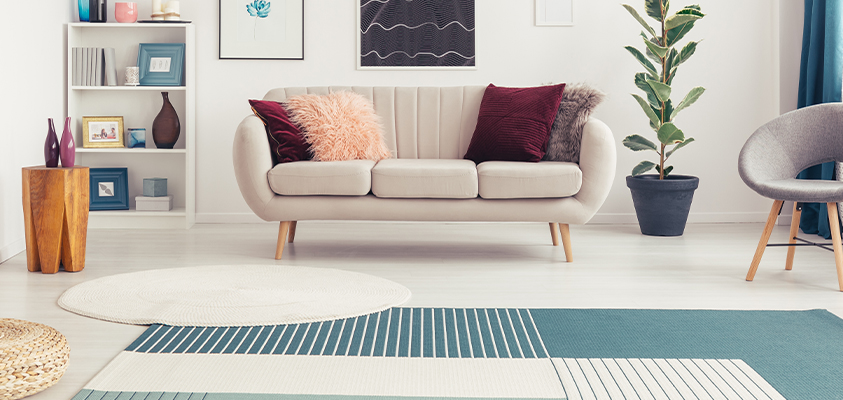 You can layer a smaller round rug over a larger square or rectangle rug for a unique decorative spin.