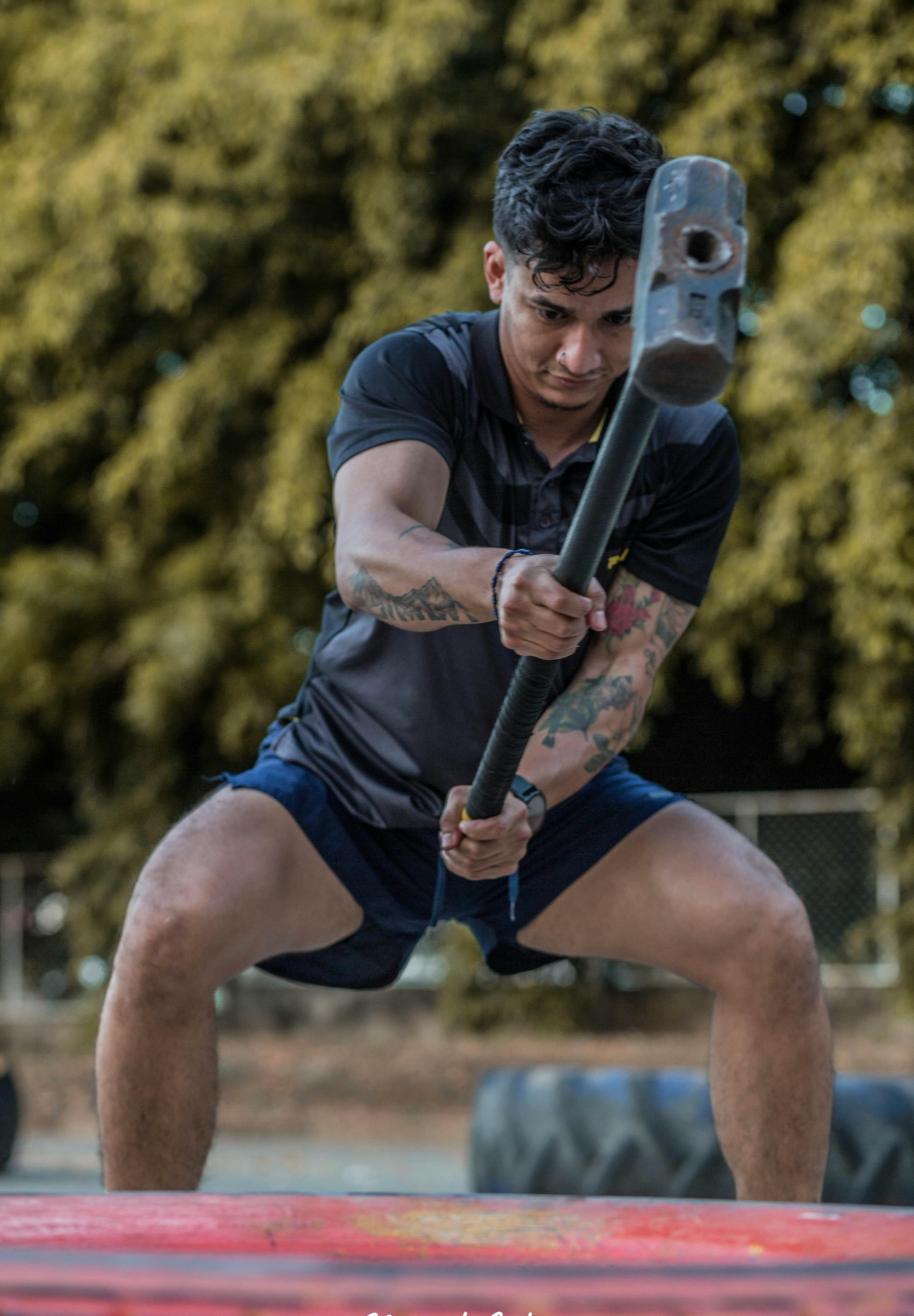 Even on an almost vertical setting on the NordBench, keeping that straight line on your body can be quite challenging to beginners, especially during the lowering portion of the movement. Photo by Manuel  Guillén Vega : https://www.pexels.com/photo/a-tattooed-man-in-sportswear-using-a-large-hammer-at-a-competition-16546924/