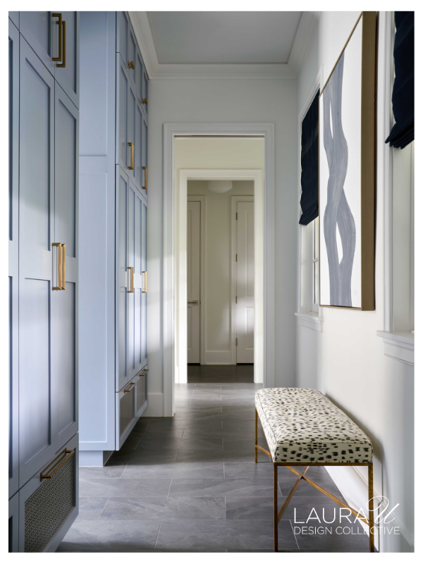 Powder blue custom mudroom lockers with brass hardware and built-in storage for an active family.