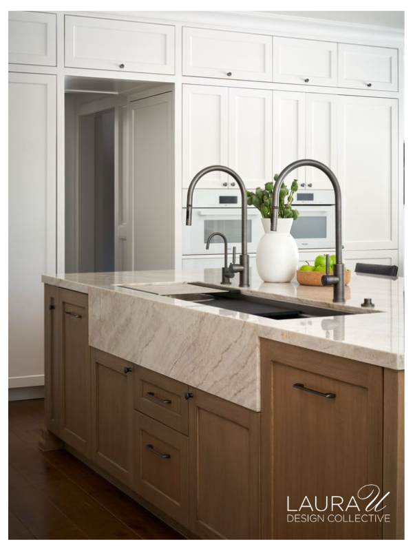 Custom kitchen at Huntwick Forest with a wood island, marble countertops, and cabinetry designed for entertaining.