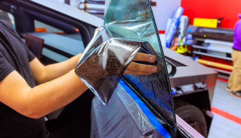 Minimizing visible light transmission using window tint film