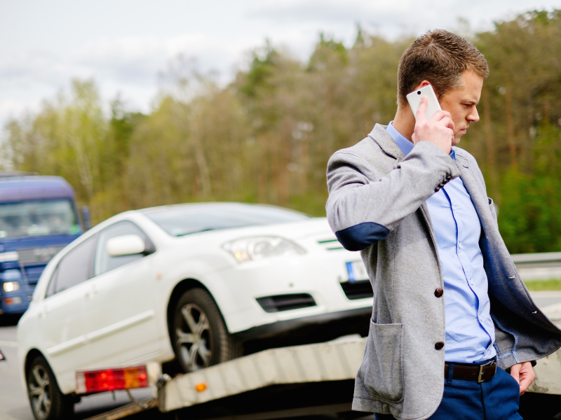 An image showing a person on the phone after a tractor trailer accident in AL.