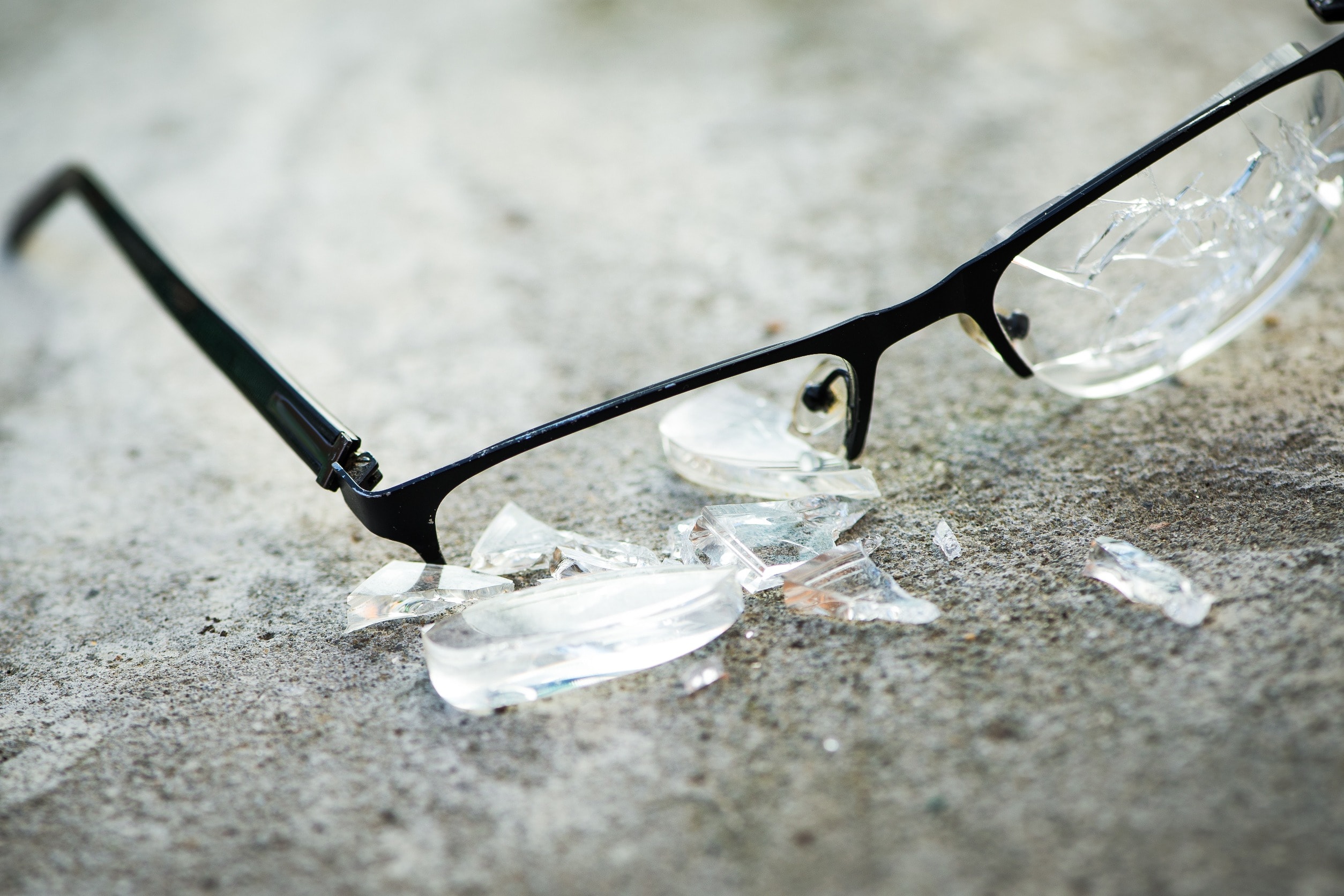 A pair of broken glasses on the floor