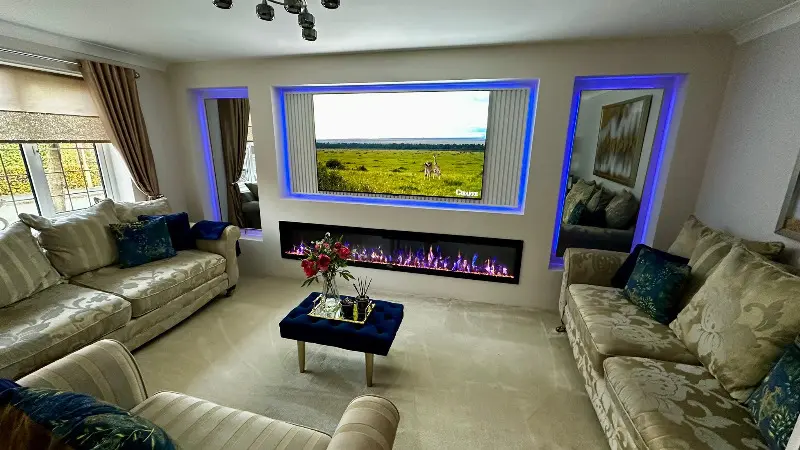 A stylish TV unit integrated into a modern living area with floating shelves.