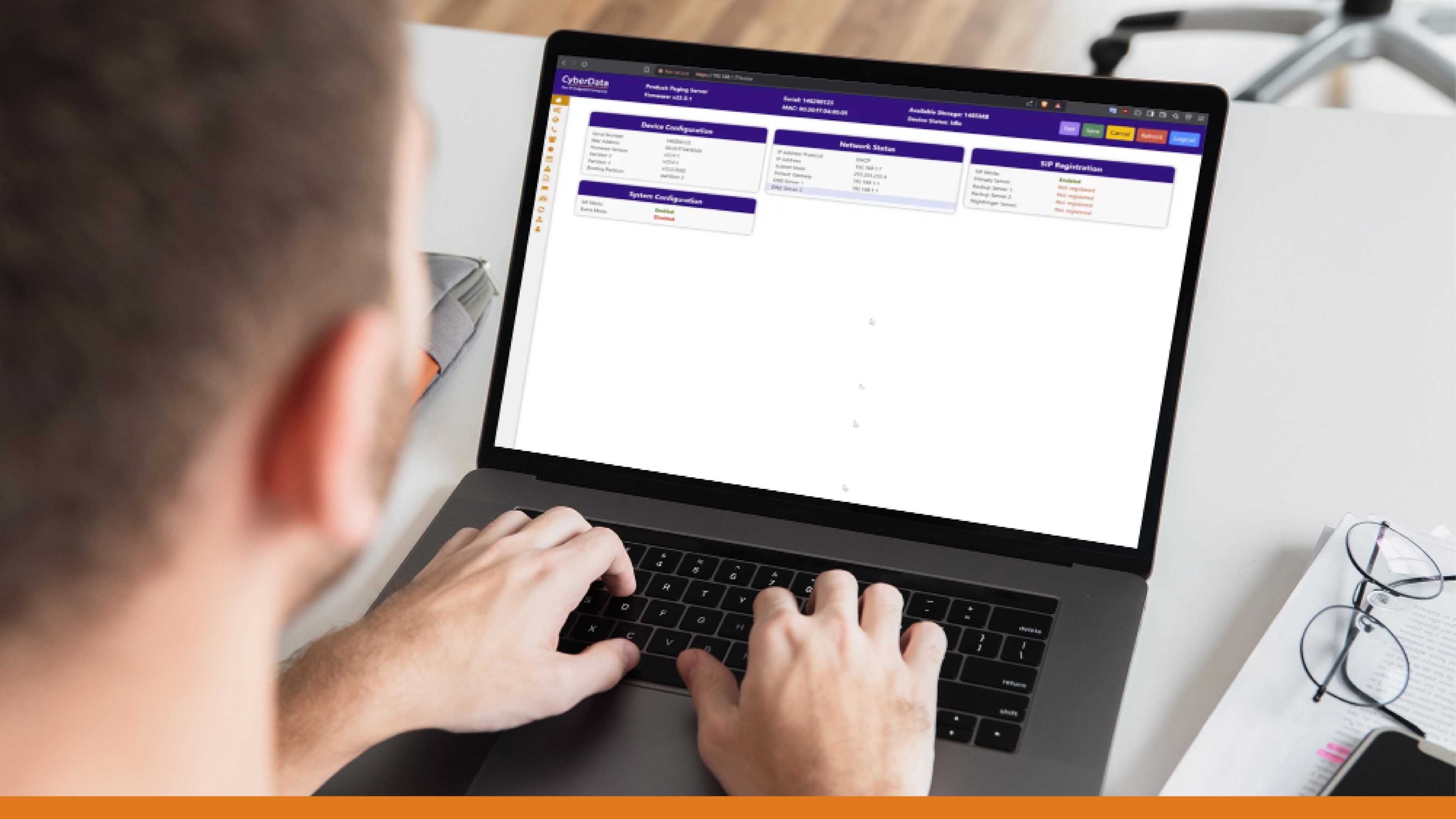 Close-up of a man working on a laptop, displaying emergency alert system software used for issuing real-time alerts during critical events and emergencies.