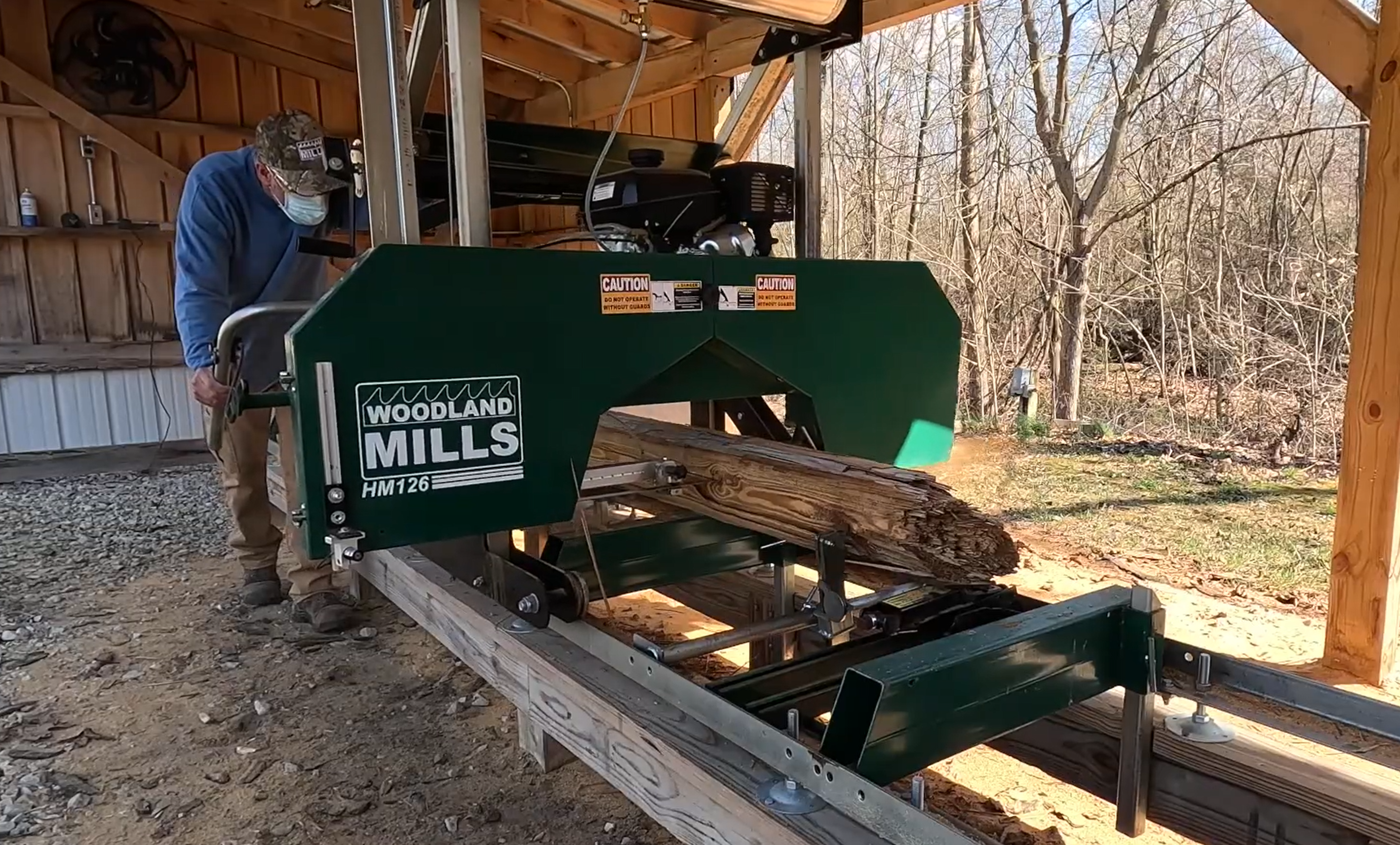 Tony milling used utility poles into boards of the same thickness so they can be used in his projects.