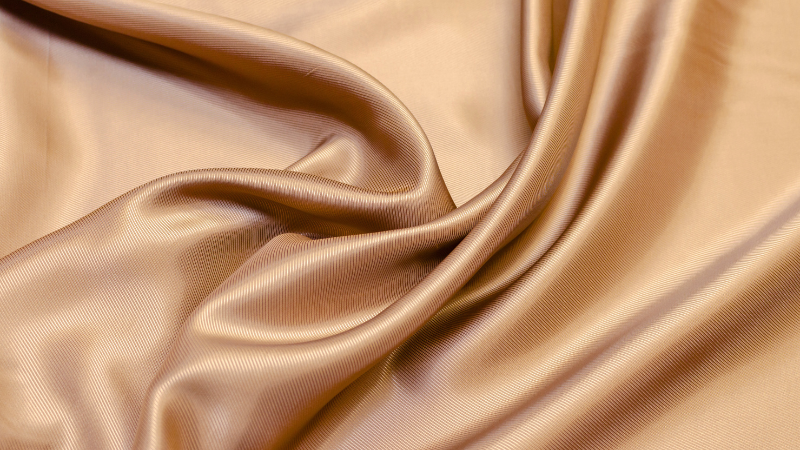 A close up of a beige viscose fabric