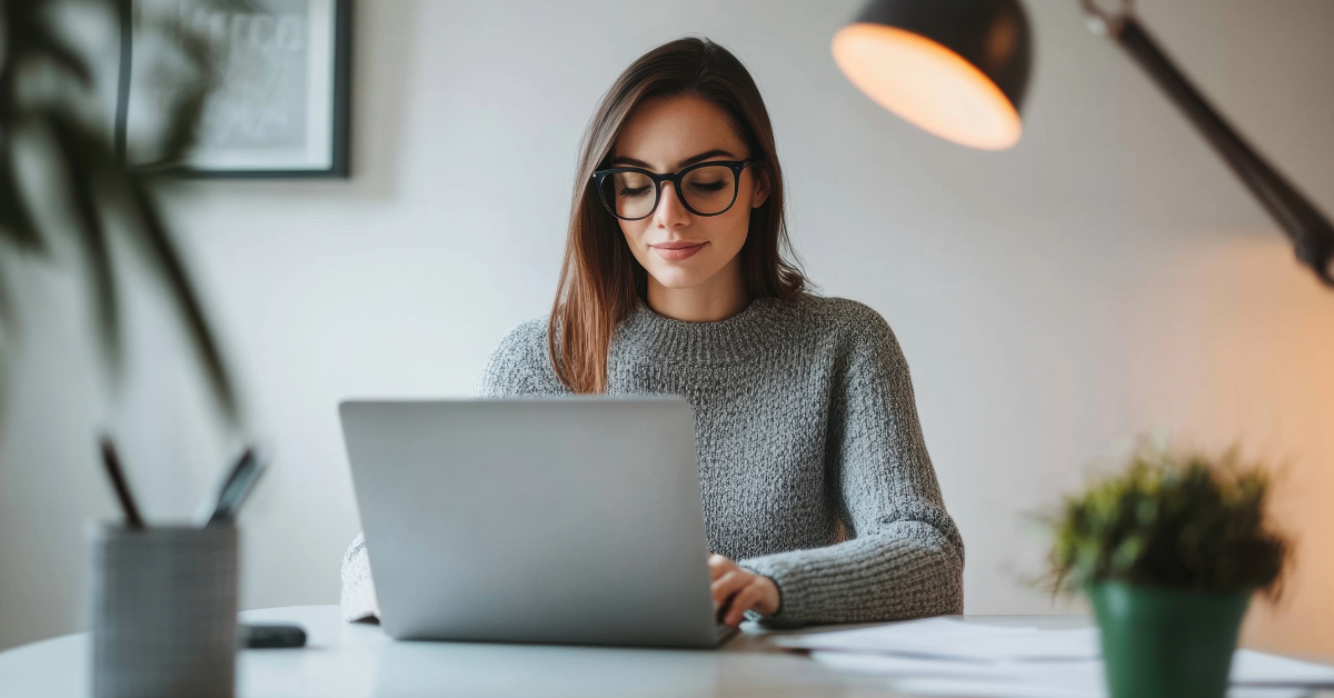 Woman managing finances at home office learning the benefits of having a CPA for OnlyFans creators.