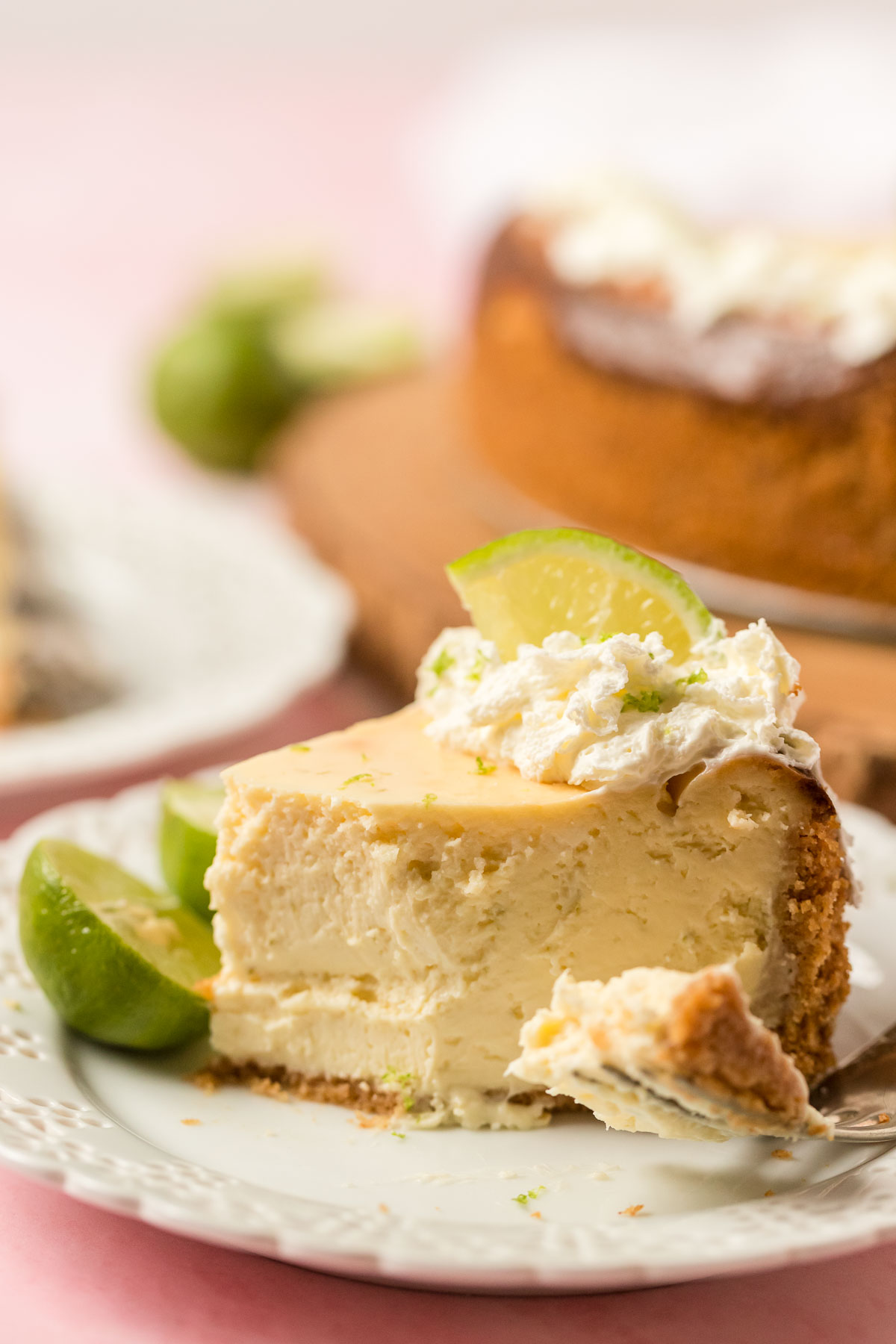 slice of key lime cheesecake on a plate with a fork