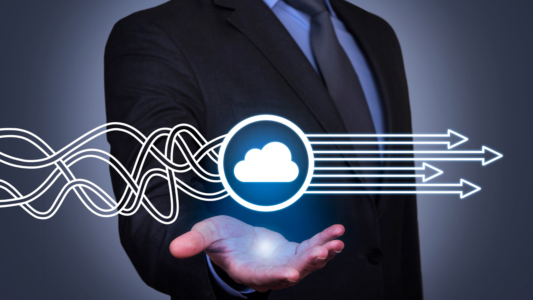 A businessman holding a digital cloud icon with interconnected lines and arrows representing cloud computing and data flow technology.