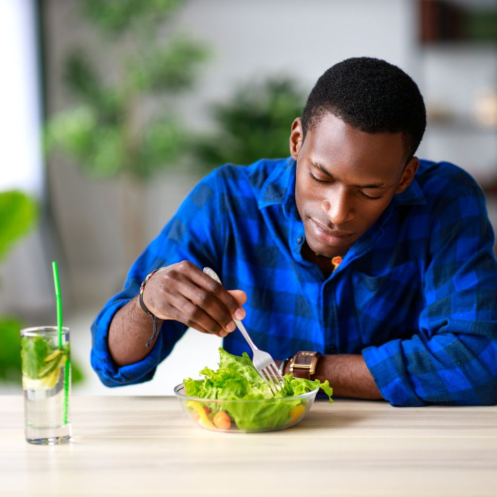 A person eating a healthy meal, highlighting the importance of diet and nutrition for liver health.